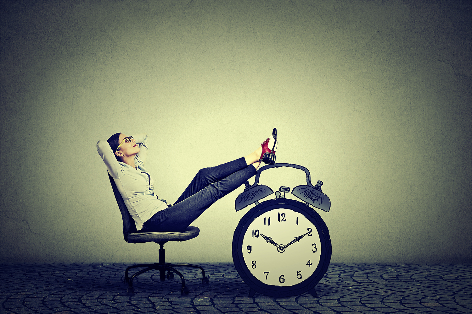 Woman relaxing on a chair with feet resting on a clock