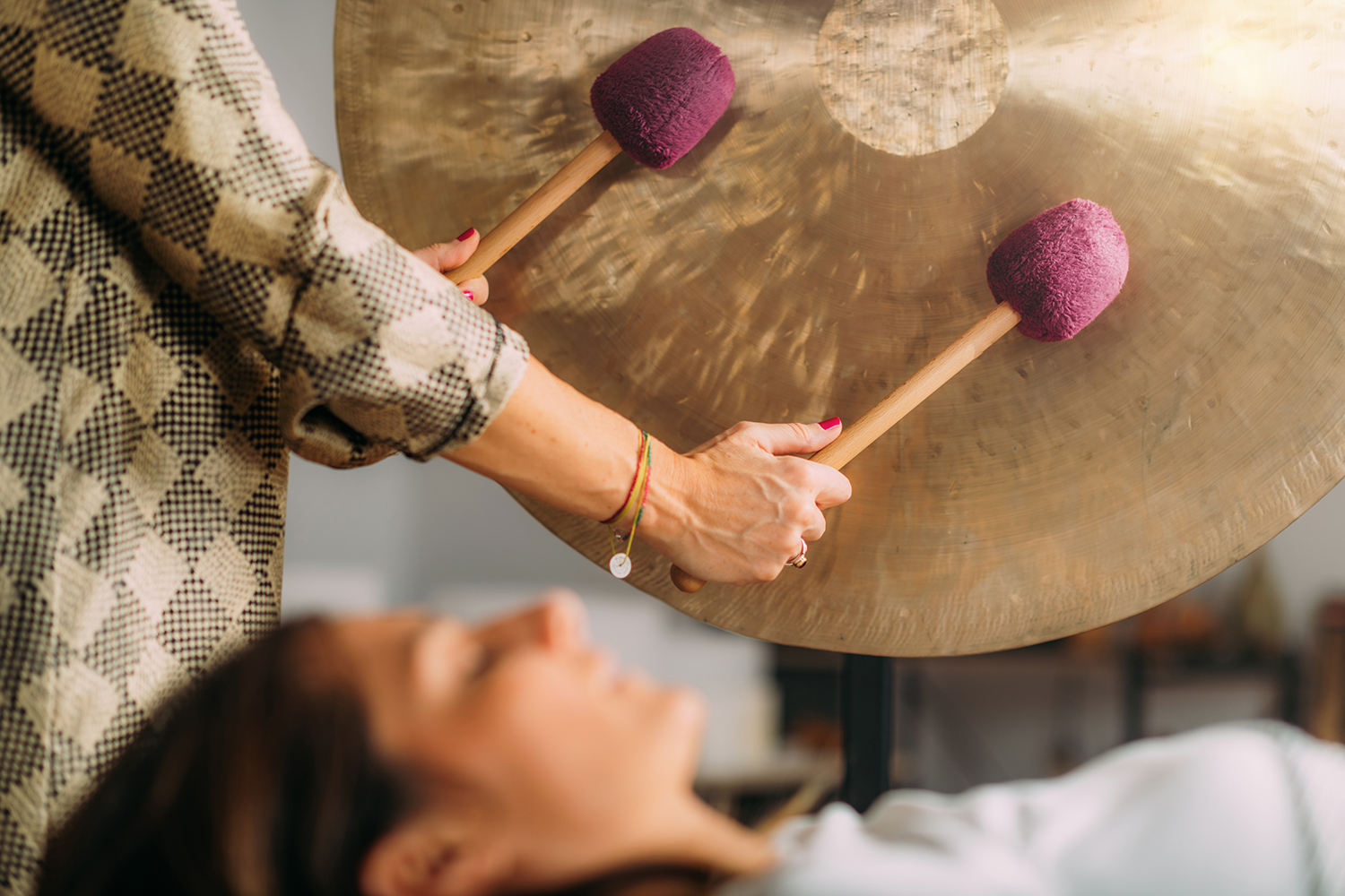 a woman receiving sound therapy