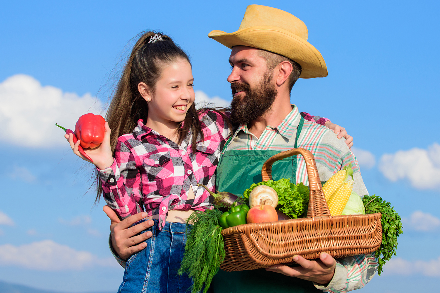 a farmer and his daughter with an organic harvest
