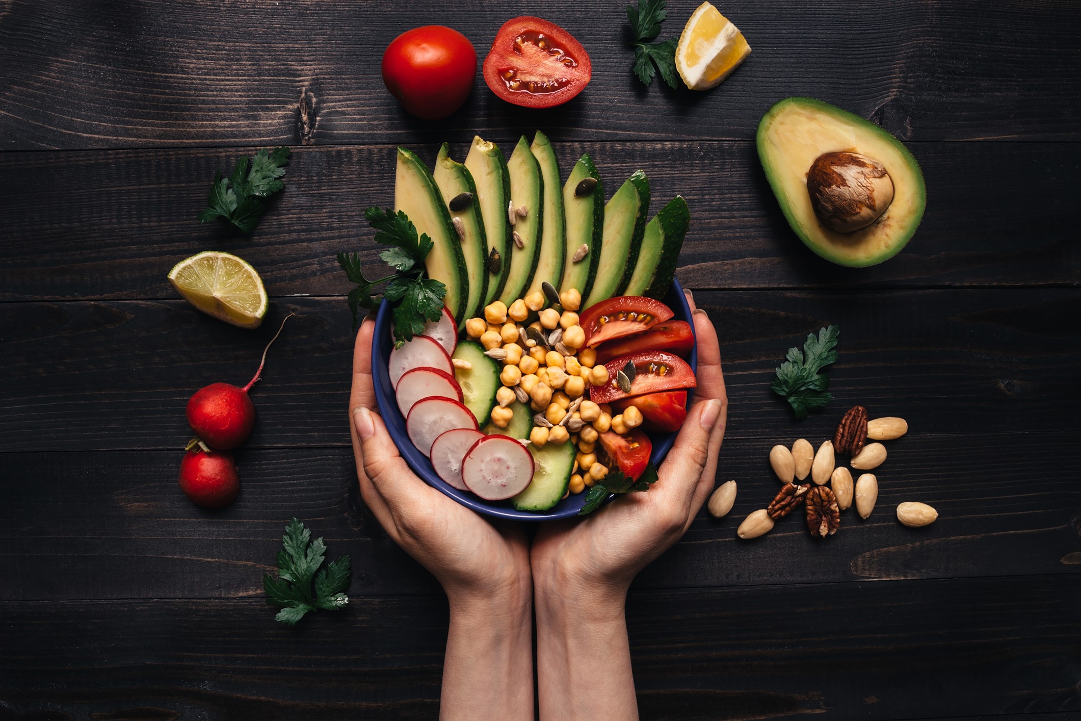Hands holding healthy salad with chickpea and vegetables. 