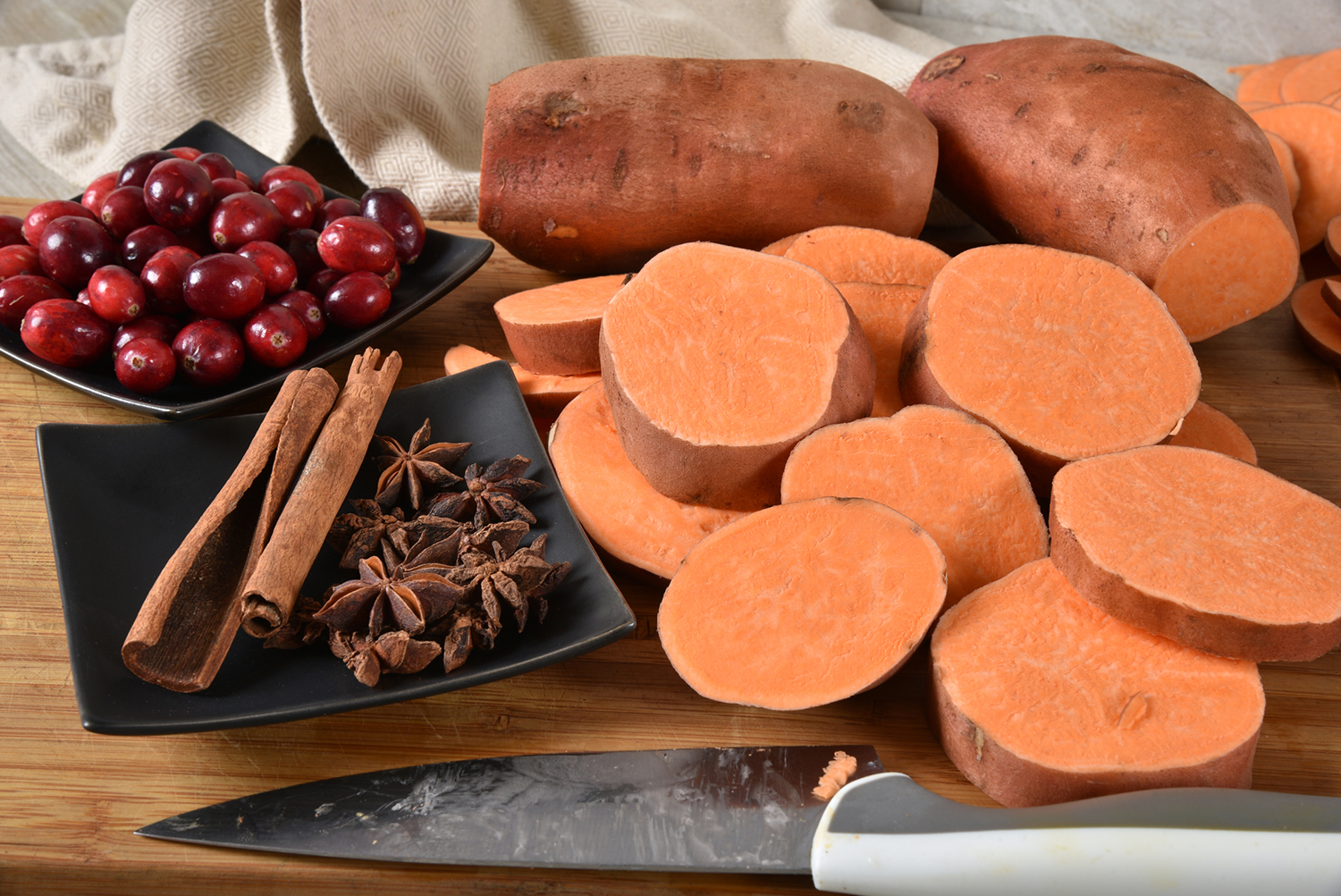 Sliced sweet potatoes, cranberries and holiday spices.