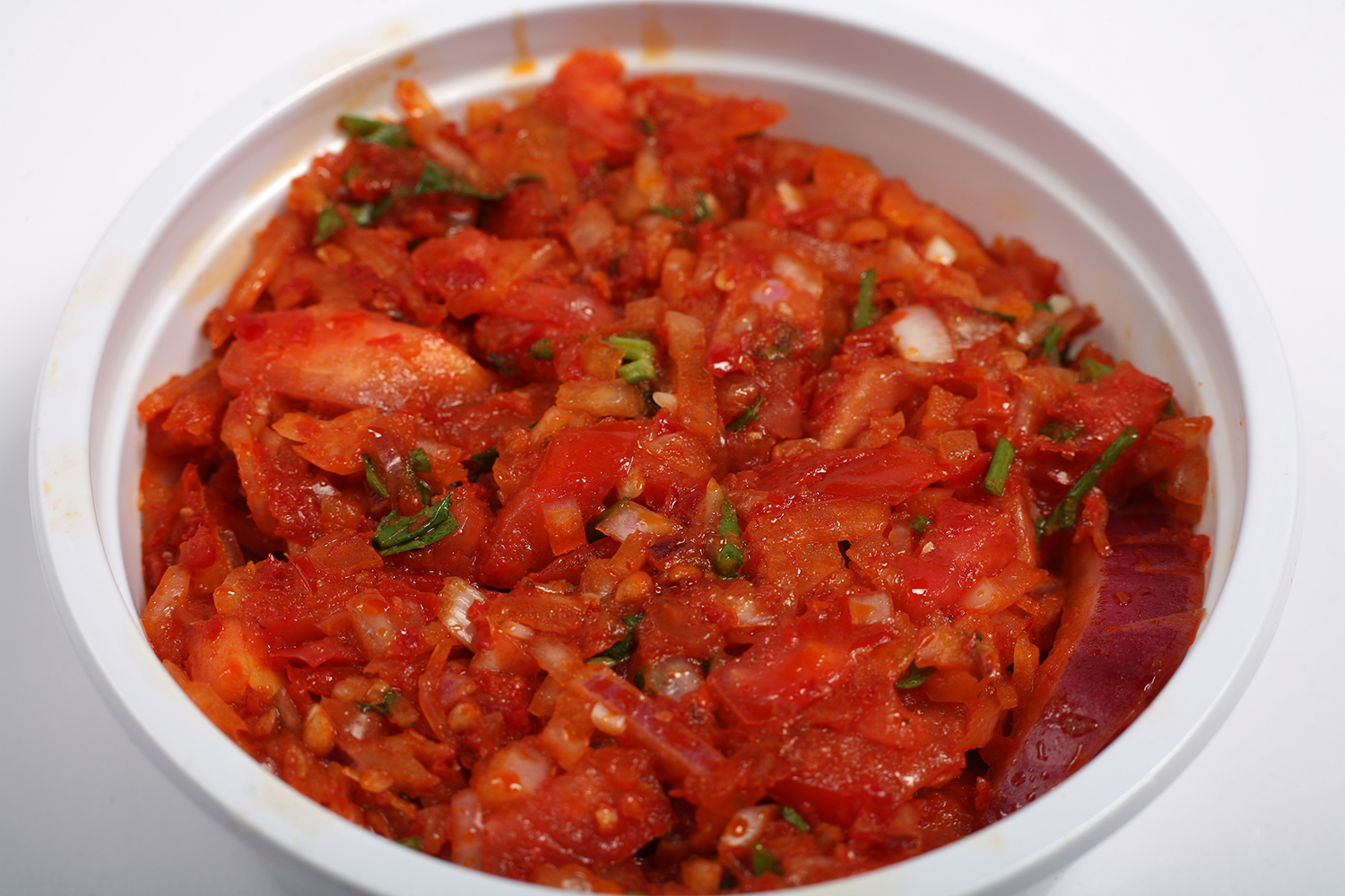 a bowl of blended tomatoes, shallot, and peppers