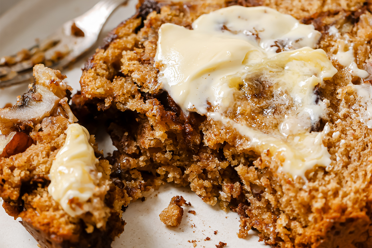a slice of banana bread slathered with cinnamon and butter