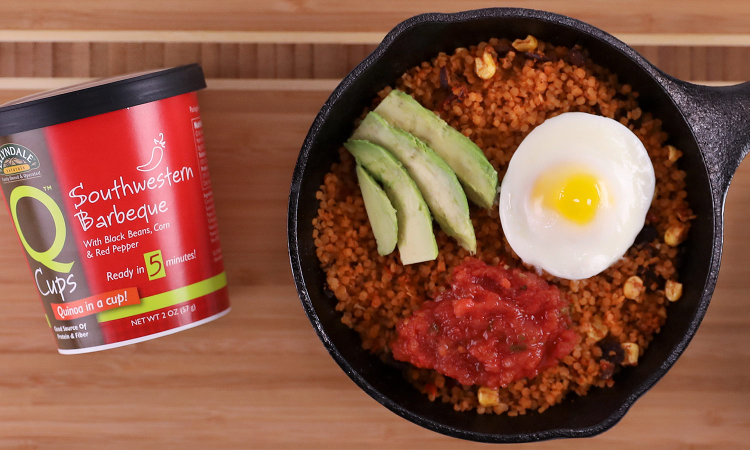 A pan of quinoa, egg, avocado, and salsa