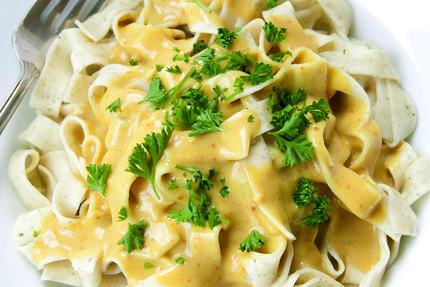 A plate of artichoke ribbon pasta with curry sauce