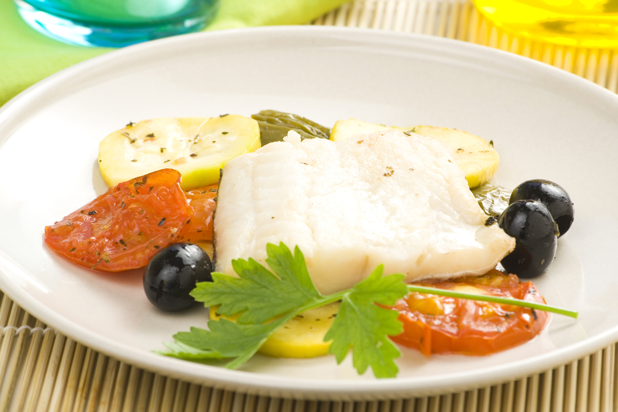 Fillet of cod baked tomatoes and black olives.