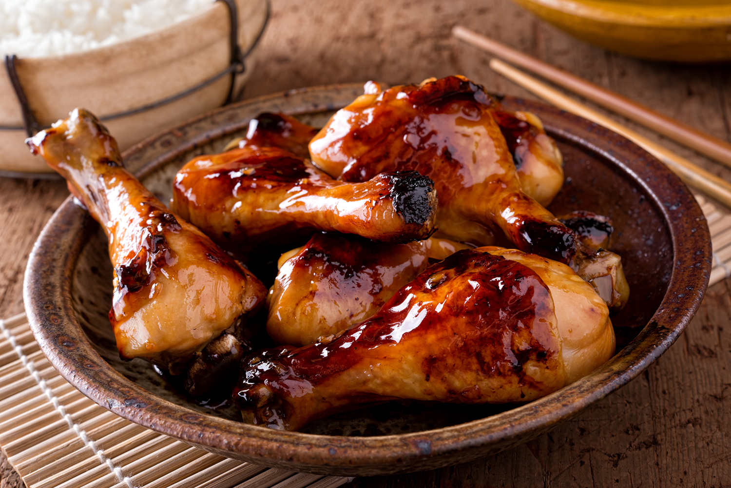 Sticky chicken on a plate ready sprinkle with scallions and serve.