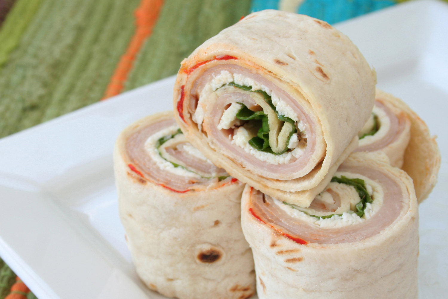 a turkey wrap sliced into four pieces