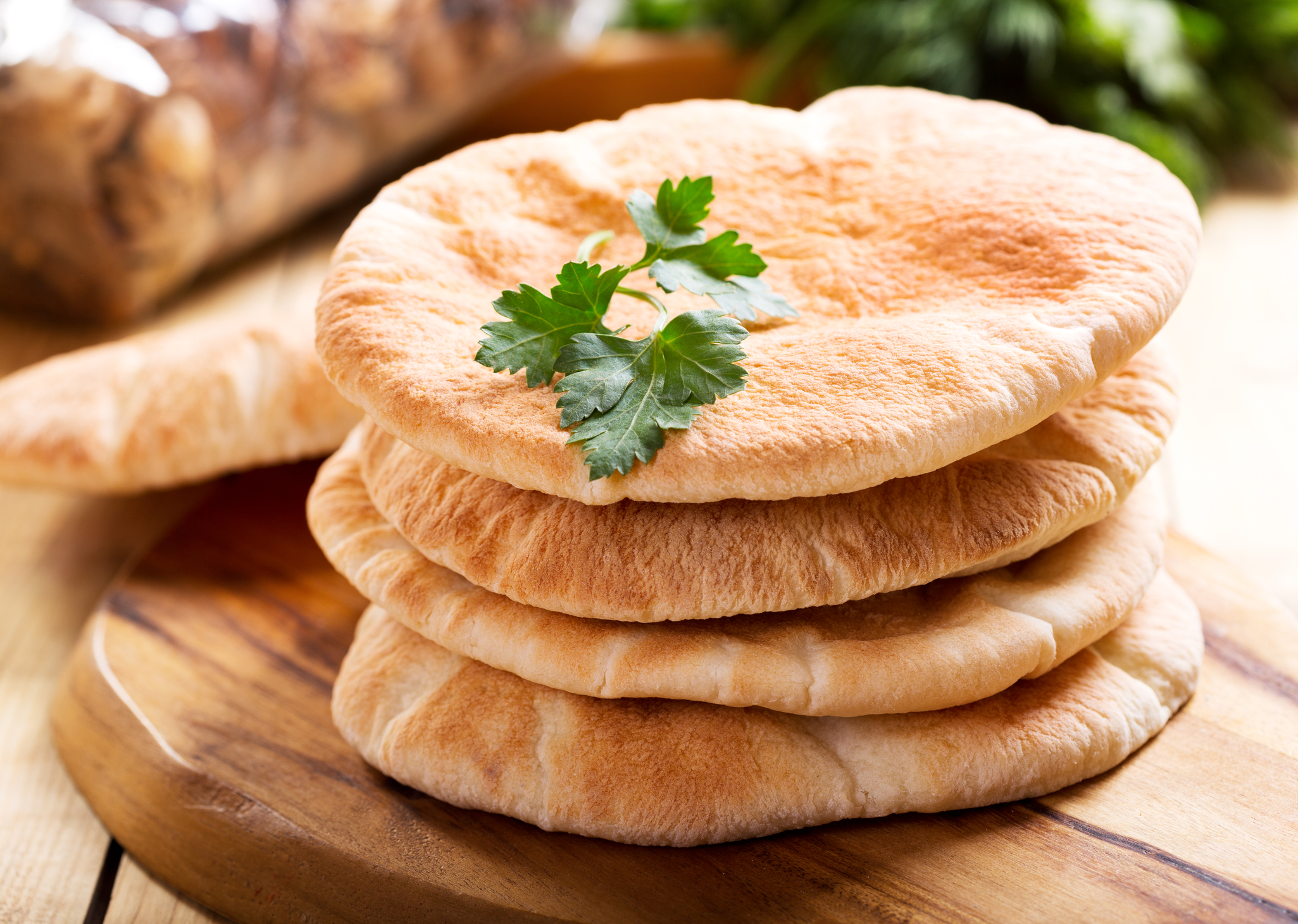 Four pieces of pita bread in a stack. 