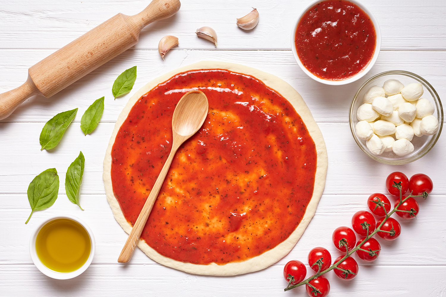 pizza sauce spread on a crust