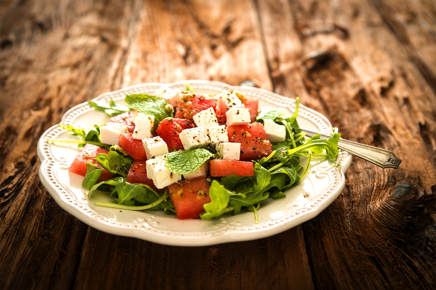 A mmix of watermelon, arugula, and feta cheese