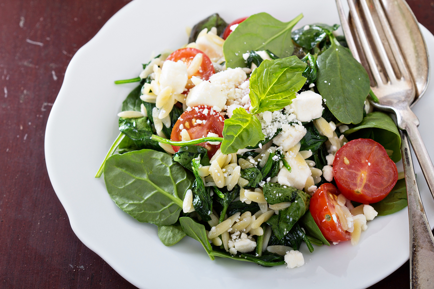 a plate of spinach with crumbled feta