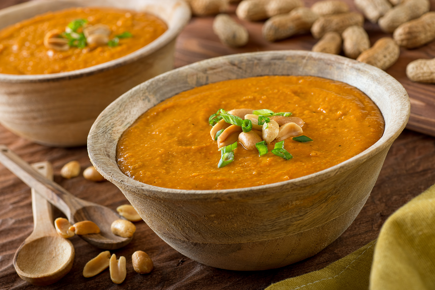 a bowl of peanut soup with garnish
