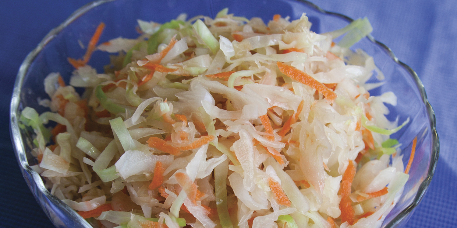 A bowl of cabbage, carrots, and sauerkraut