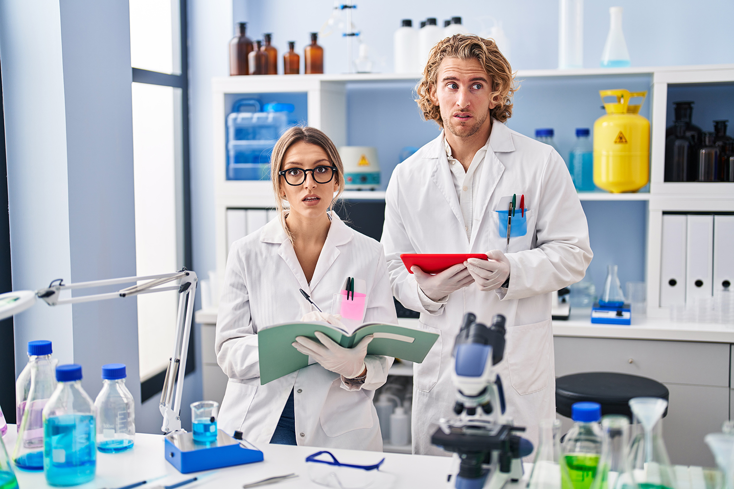 two medical researchers looking very confused and slightly guilty