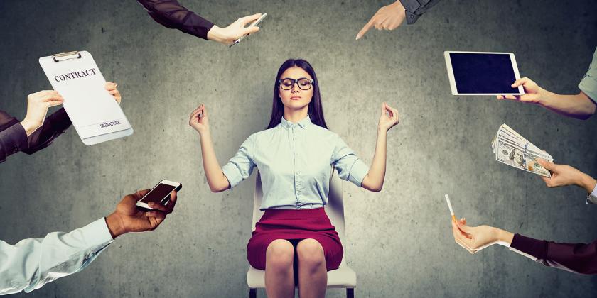 a woman meditating to reduce the stress of modern life and work
