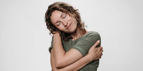 a woman hugging herself warmly