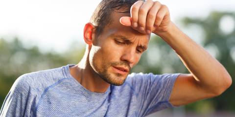 A fit man experiencing fatigue during his workout