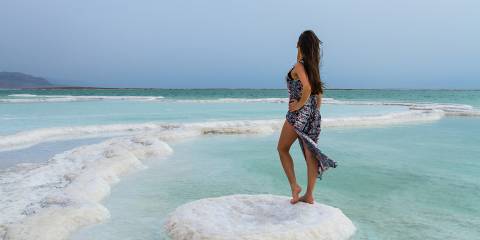 A healthy woman standing by the Dead Sea