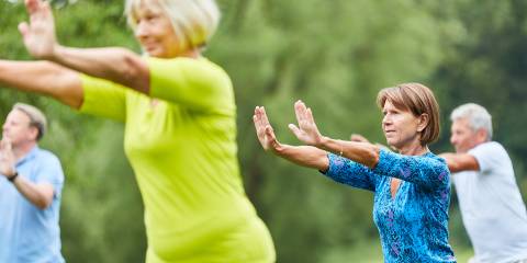 a group of senior men and women practicing t'ai chi
