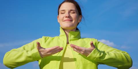 a woman breathing clean mountain air