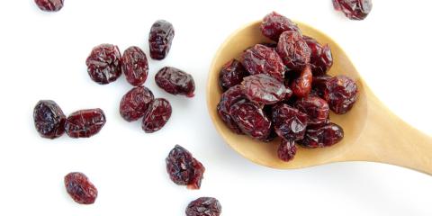 Dried cranberries in a wooden spoon. 