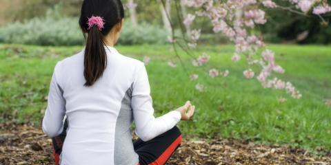 Woman meditating in a park. 