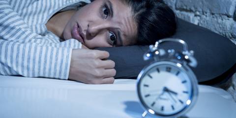 a man that fell asleep on the couch eating junk food