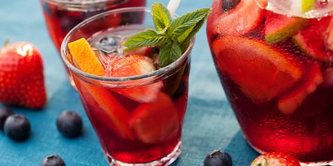a sparkling punch mocktail with cut fruit and garnish