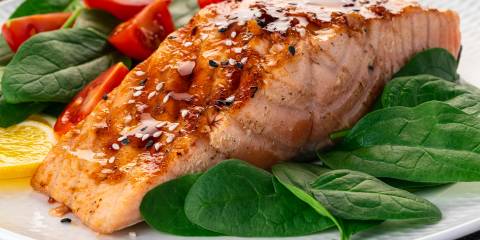 roasted salmon on a bed of greens