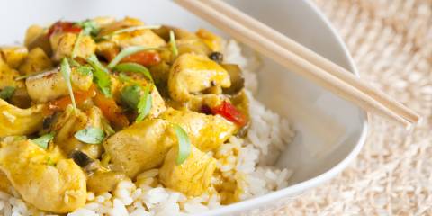 a bowl of curried chicken on jasmine rice