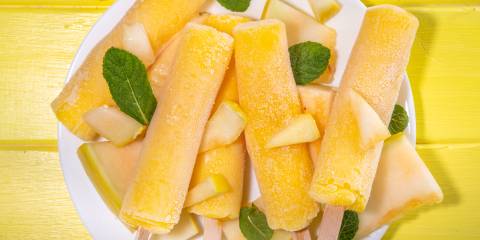 a plate of freshly frozen cantaloupe pops