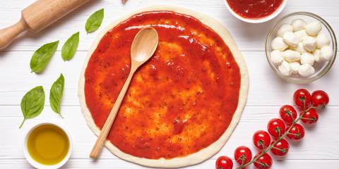 pizza sauce spread on a crust