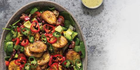 Top view of Fried Plantain, Spicy Beans & Yogurt Dressing in a grey stoneware serving dish.