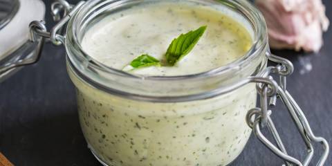 Tofu Basil Dressing in a glass flip to jar.