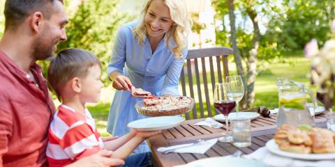 a mother serving her family pie at a cookout