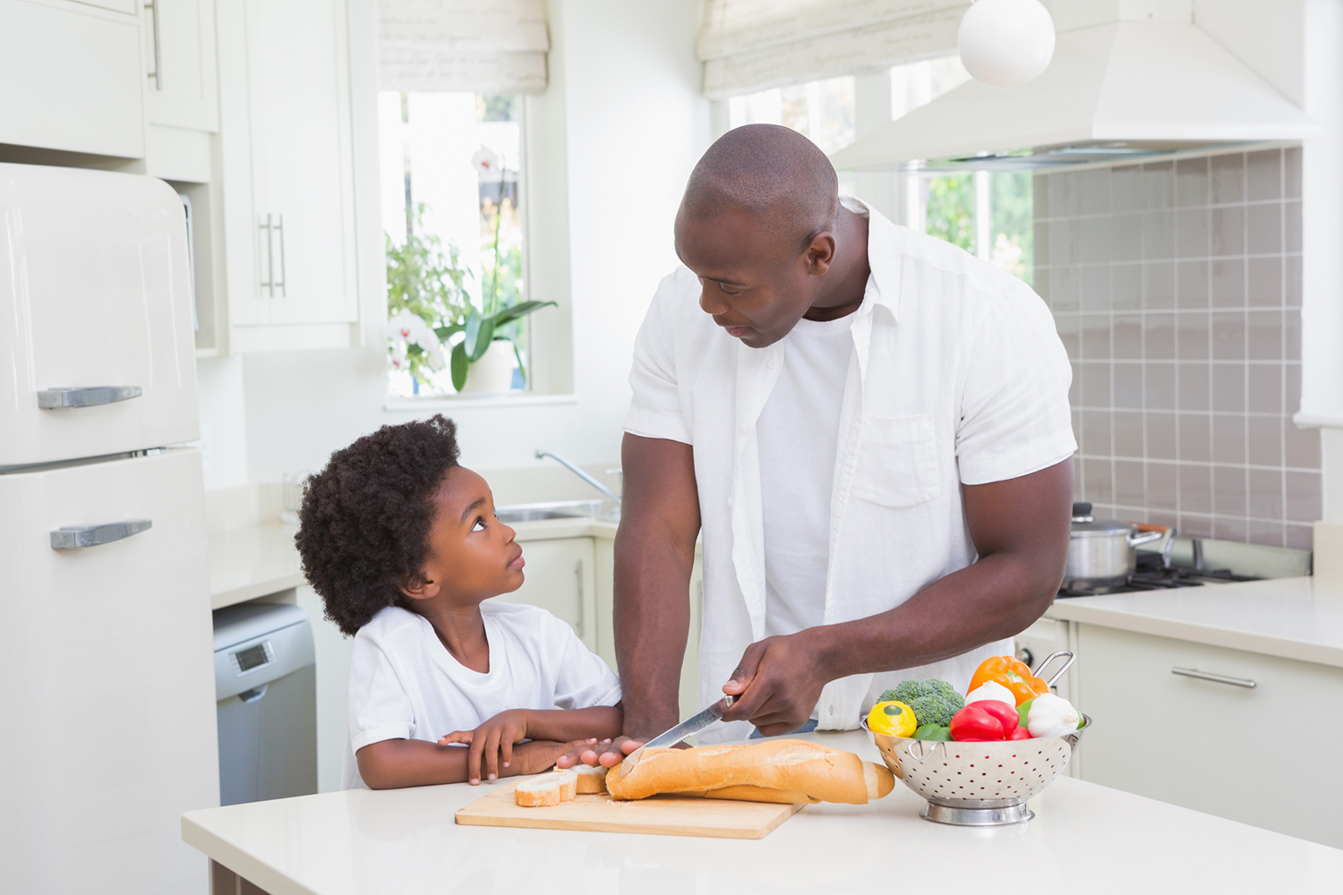a father and son preparing a healthy meal in the kitchen