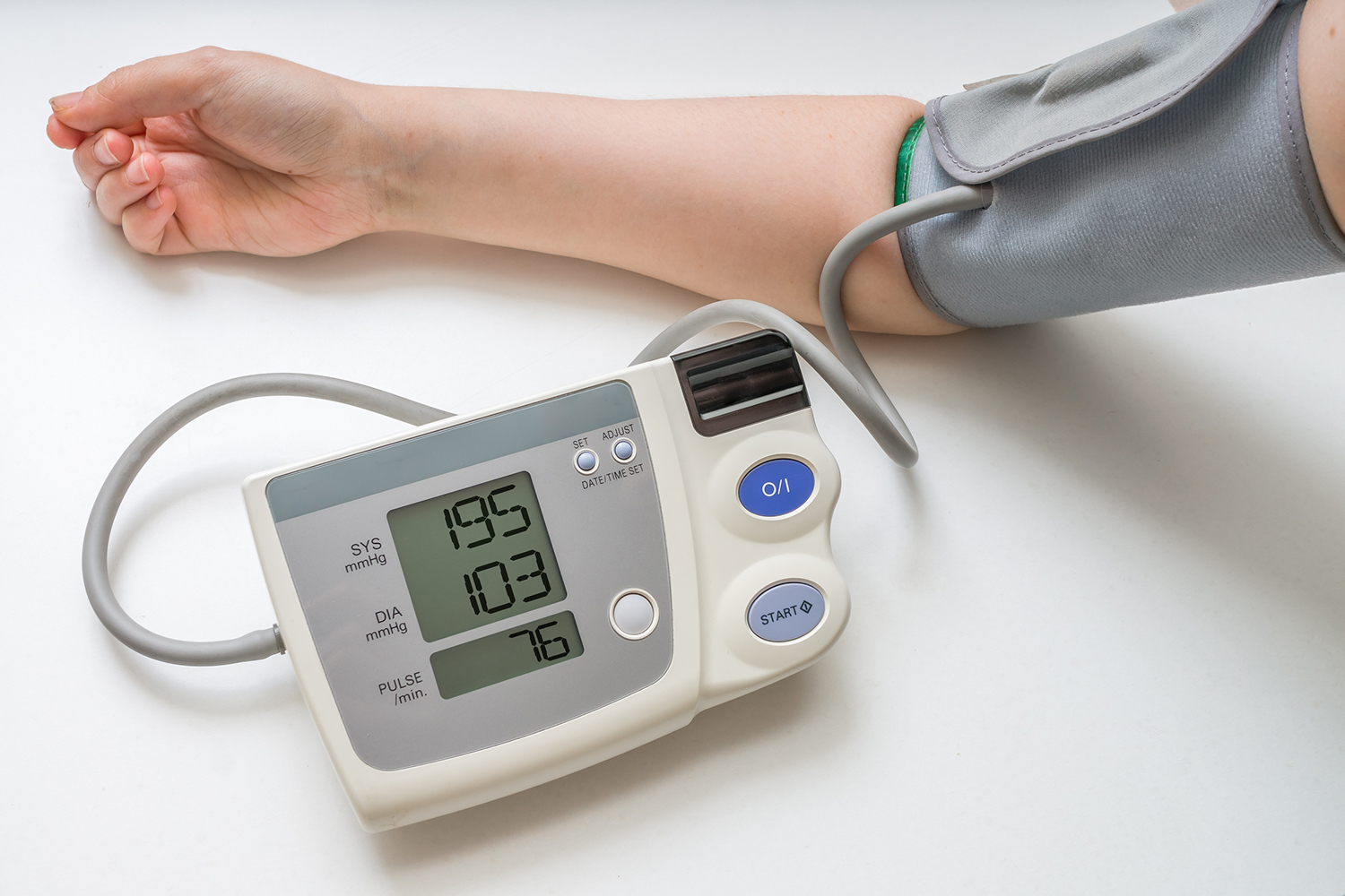 a woman using an at-home blood pressure sensor