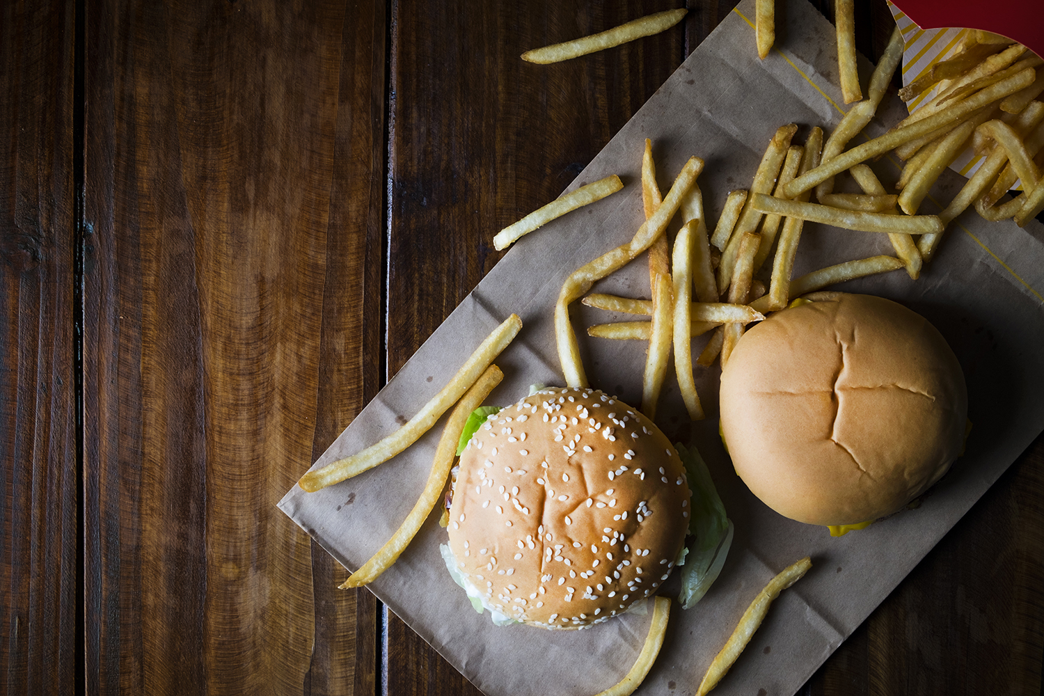 Burgers and fries on a greasy wrapper