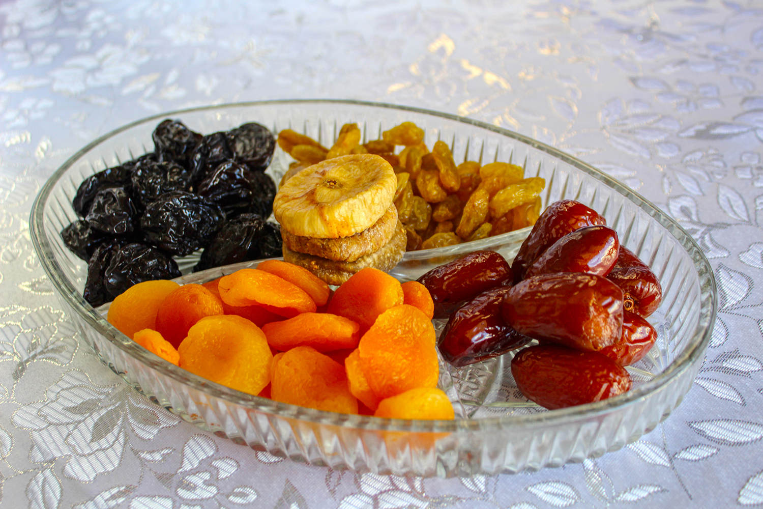 a glass tray of dried fruit