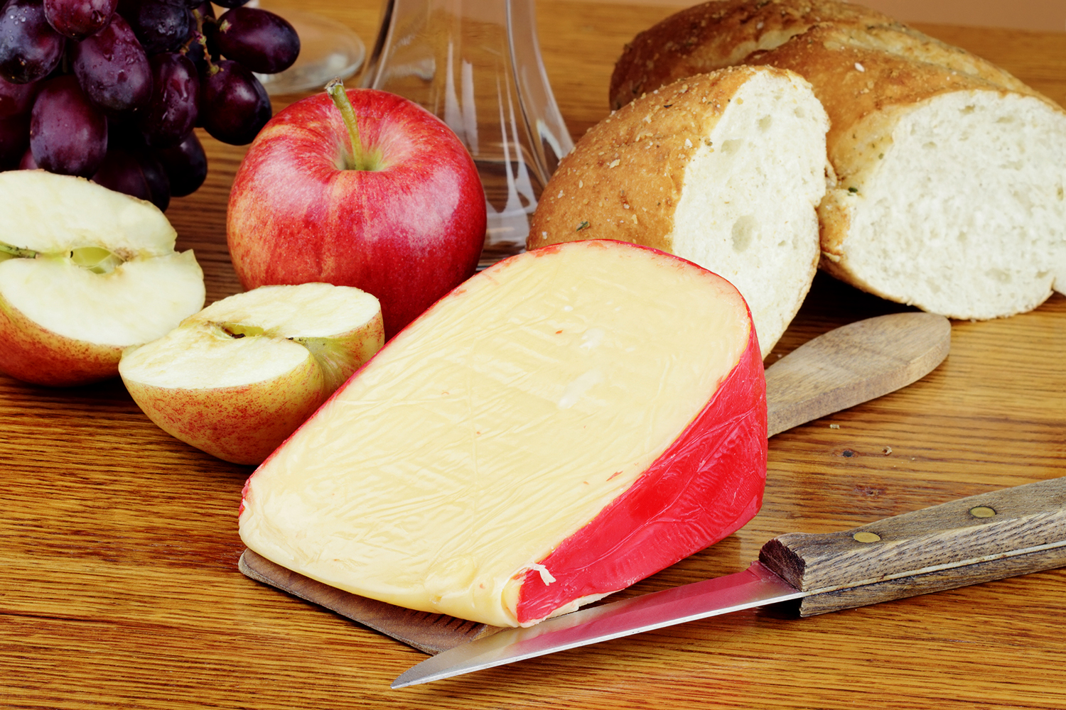 sliced apples, a paring knife, and a block of cheese